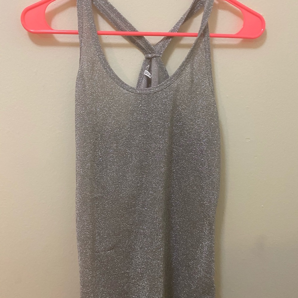 Sheer gray razor back tank top represents glitter
